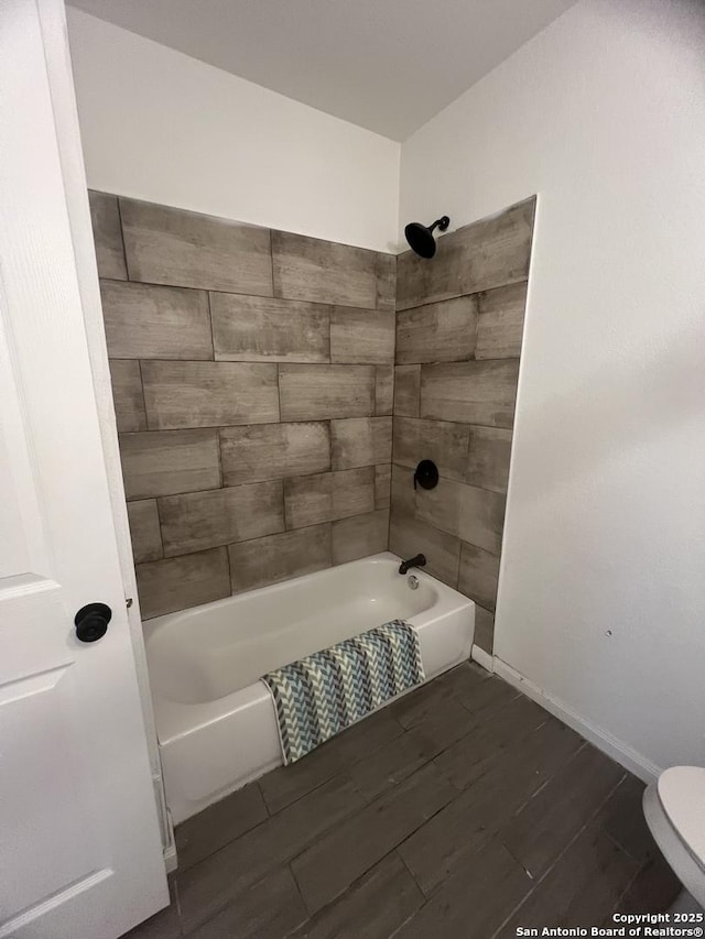 full bathroom featuring toilet,  shower combination, and wood tiled floor