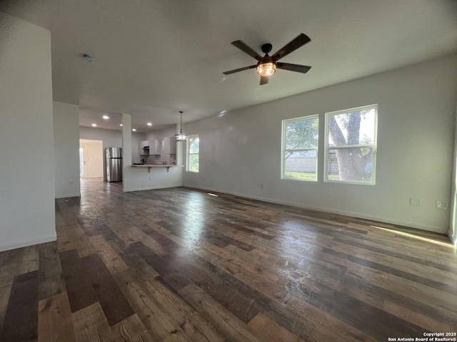 unfurnished living room featuring baseboards, recessed lighting, dark wood-style flooring, and ceiling fan