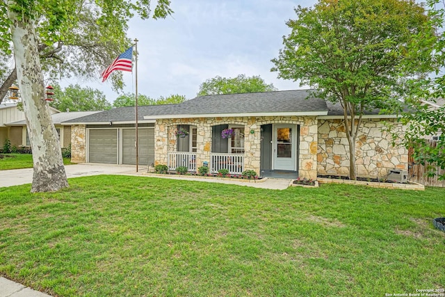 ranch-style house with covered porch, a front yard, a garage, concrete driveway, and stone siding