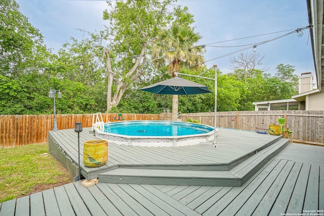 deck with a fenced in pool and a fenced backyard