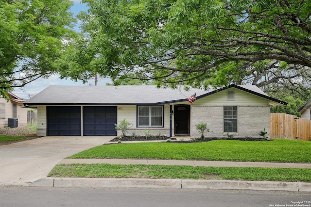 ranch-style home featuring fence, an attached garage, central AC, a front yard, and driveway