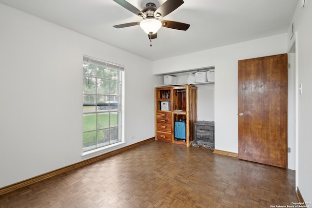 unfurnished bedroom with baseboards, ceiling fan, multiple closets, and visible vents