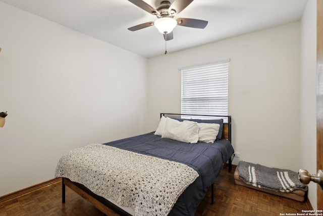 bedroom with baseboards and ceiling fan