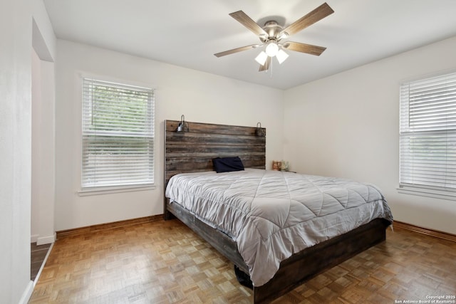 bedroom with baseboards and ceiling fan