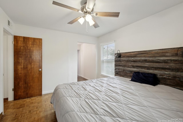 bedroom with visible vents, a ceiling fan, and baseboards
