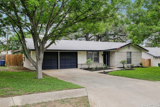 ranch-style house featuring fence, brick siding, a garage, a front yard, and concrete driveway