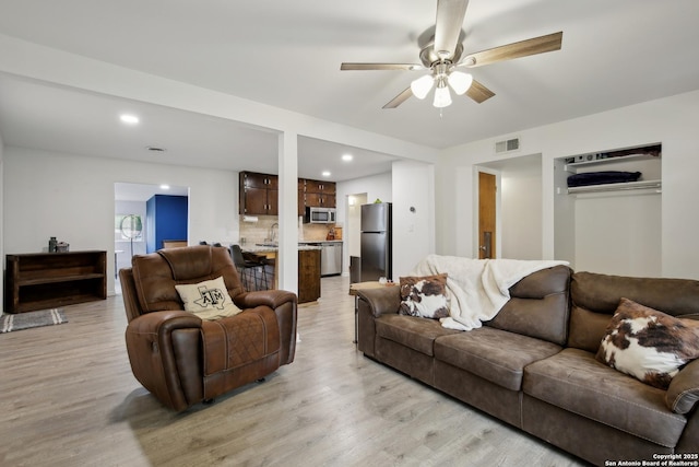 living area with recessed lighting, ceiling fan, light wood-type flooring, and visible vents