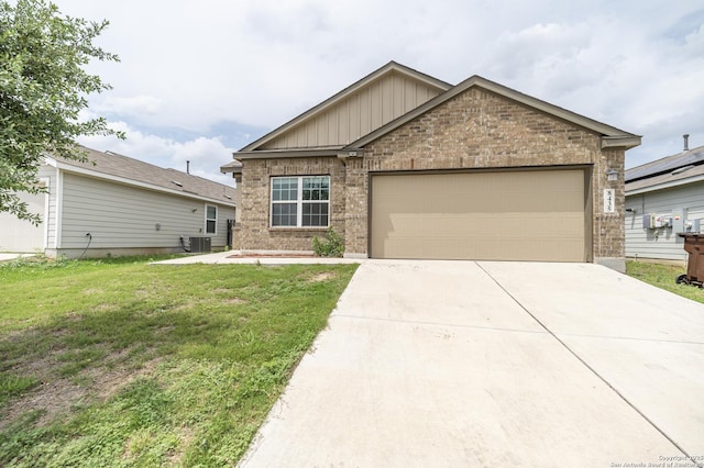 view of front facade with a front lawn, brick siding, central AC unit, an attached garage, and driveway