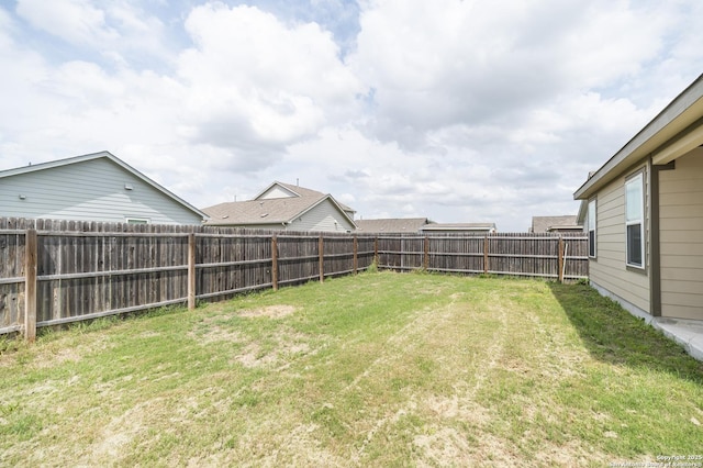view of yard with a fenced backyard