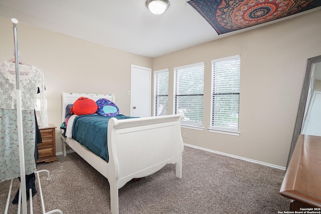 carpeted bedroom featuring baseboards