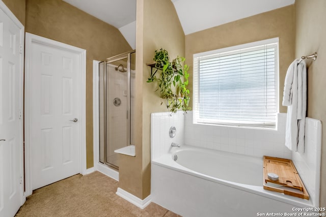 full bath with baseboards, lofted ceiling, a shower stall, and a garden tub