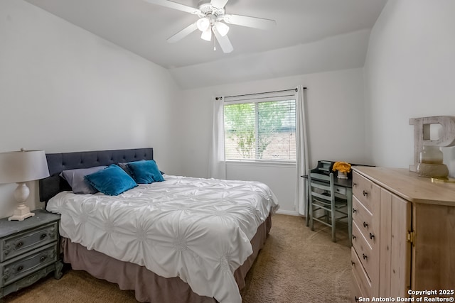 bedroom with light colored carpet, a ceiling fan, baseboards, and vaulted ceiling
