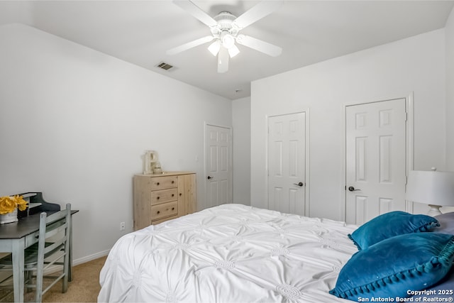 bedroom featuring visible vents, a ceiling fan, baseboards, and light carpet