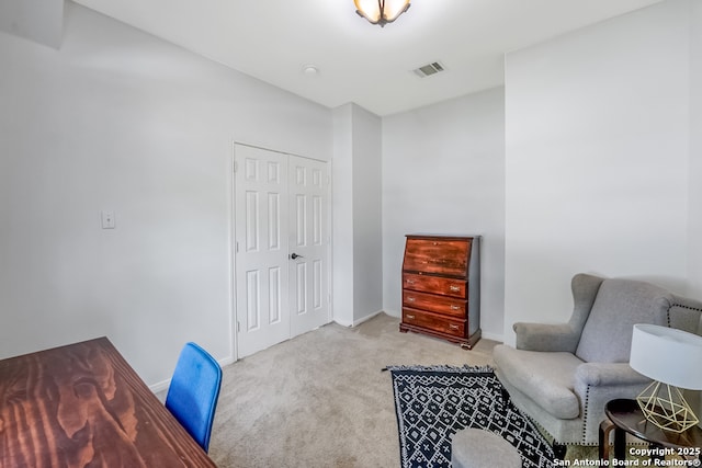sitting room with carpet flooring, baseboards, and visible vents