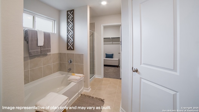 full bath featuring tile patterned flooring, a bath, baseboards, and a stall shower