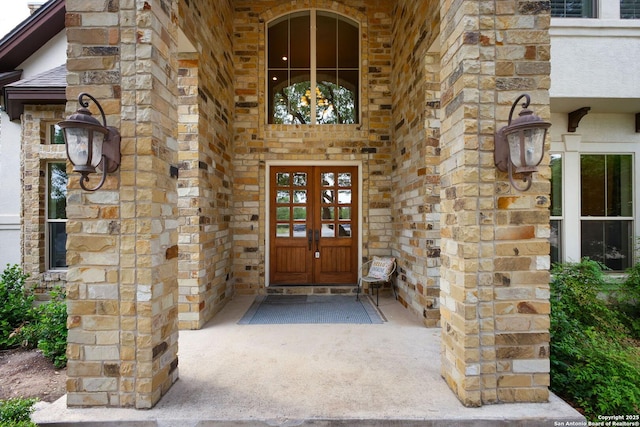 property entrance with french doors and stone siding
