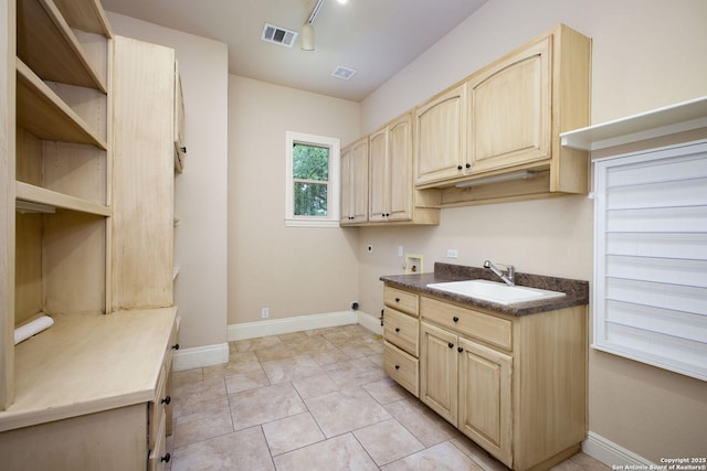 laundry area with washer hookup, hookup for an electric dryer, visible vents, cabinet space, and a sink