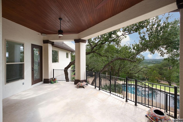 view of patio / terrace with a ceiling fan and a balcony