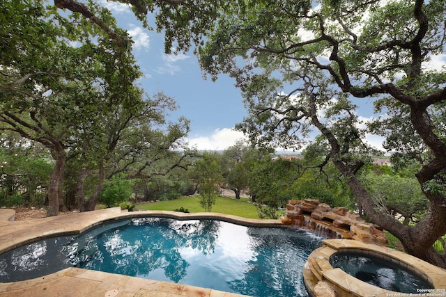 view of swimming pool featuring a pool with connected hot tub