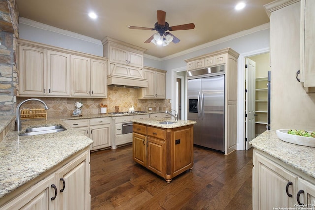 kitchen with dark wood-type flooring, a sink, a ceiling fan, and stainless steel appliances