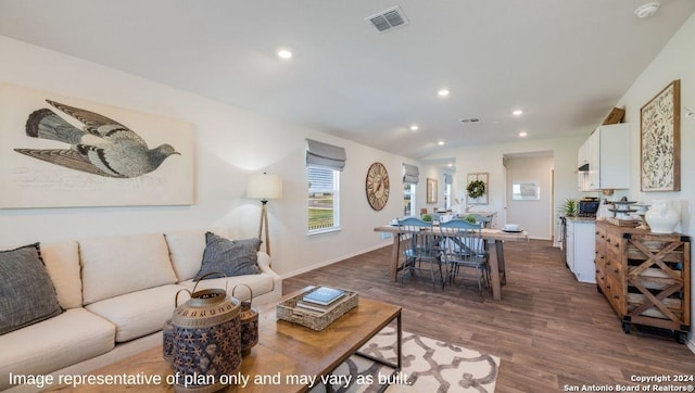 living room with visible vents, recessed lighting, dark wood finished floors, and baseboards