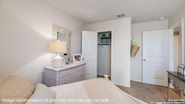 bedroom with visible vents, baseboards, carpet floors, and a closet