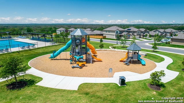 communal playground with a community pool and a residential view