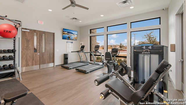 exercise room featuring visible vents, a ceiling fan, wood finished floors, and recessed lighting