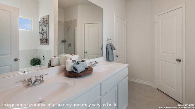 full bathroom with double vanity, a sink, tile patterned floors, and tiled shower