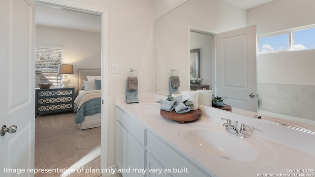 full bathroom featuring double vanity, a healthy amount of sunlight, a sink, and ensuite bathroom