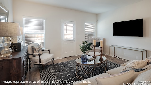 living area with baseboards and wood finished floors