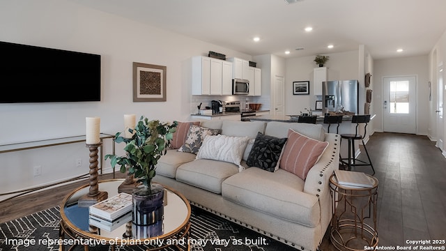 living room with recessed lighting, baseboards, and dark wood finished floors
