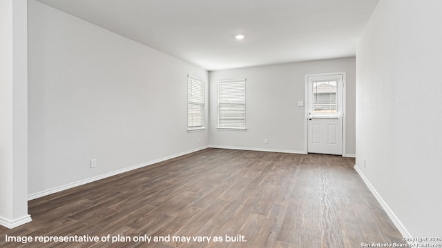 unfurnished room with baseboards, recessed lighting, and wood finished floors