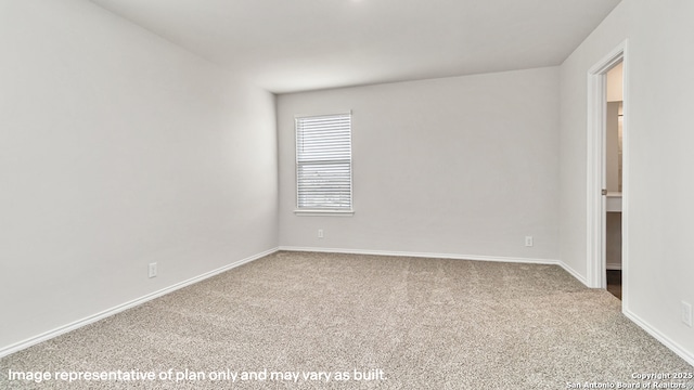 carpeted empty room with baseboards