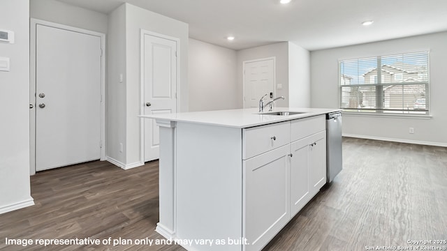 kitchen featuring white cabinets, a sink, light countertops, dark wood-type flooring, and stainless steel dishwasher