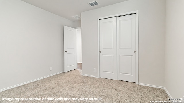 unfurnished bedroom with light colored carpet, baseboards, visible vents, and a closet