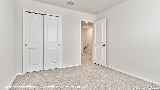 unfurnished bedroom with visible vents, carpet flooring, baseboards, and a closet
