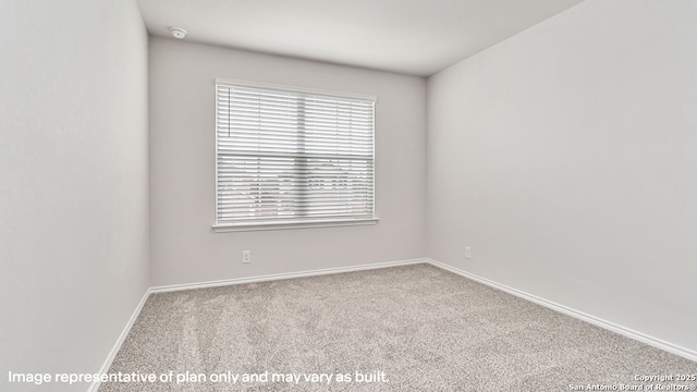 unfurnished room featuring carpet flooring and baseboards