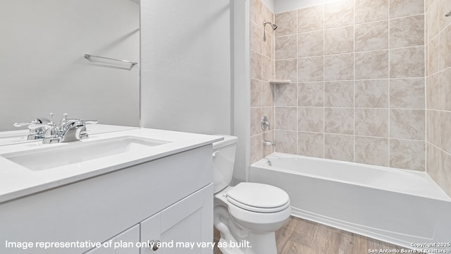 full bath with shower / bath combination, vanity, toilet, and wood finished floors