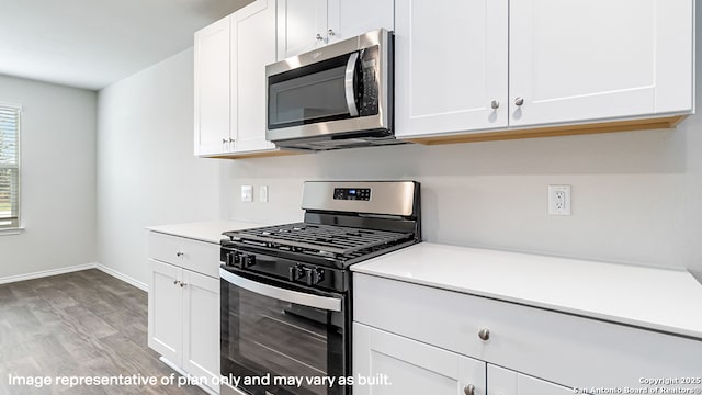 kitchen featuring appliances with stainless steel finishes, light countertops, baseboards, white cabinets, and light wood-style flooring