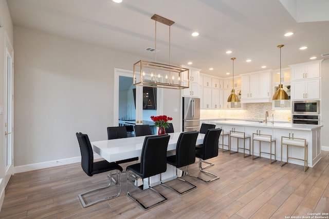 dining space with recessed lighting, baseboards, visible vents, and light wood-style flooring