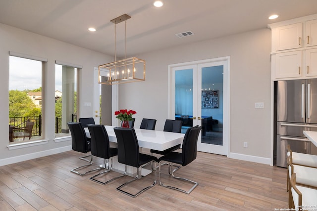 dining area with baseboards, visible vents, french doors, and light wood-style flooring