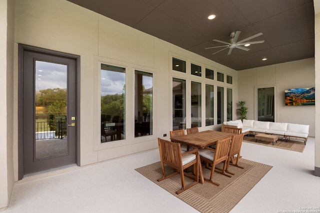 view of patio featuring ceiling fan, an outdoor living space, and outdoor dining space