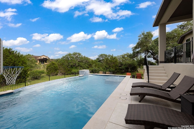 view of pool featuring a fenced in pool, fence, a patio area, and stairway