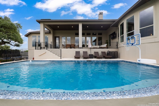 view of swimming pool featuring stairs, fence, and a fenced in pool