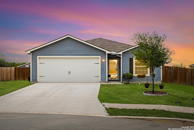 ranch-style home with a garage, a front lawn, fence, and driveway