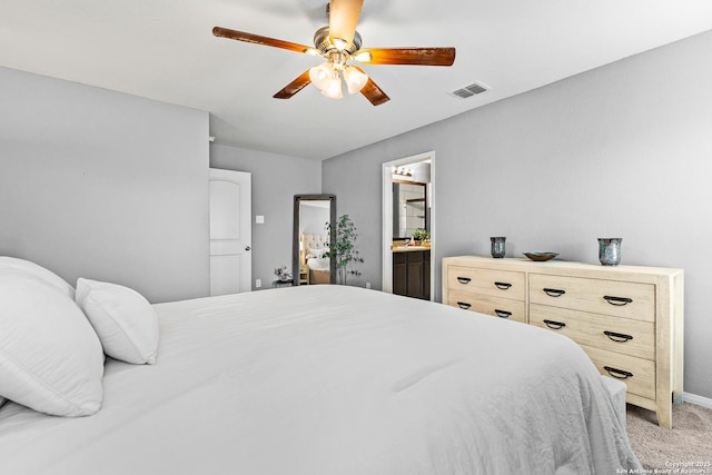 bedroom featuring connected bathroom, ceiling fan, light colored carpet, baseboards, and visible vents