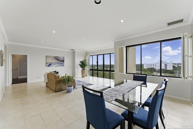 dining room featuring crown molding, visible vents, and a healthy amount of sunlight