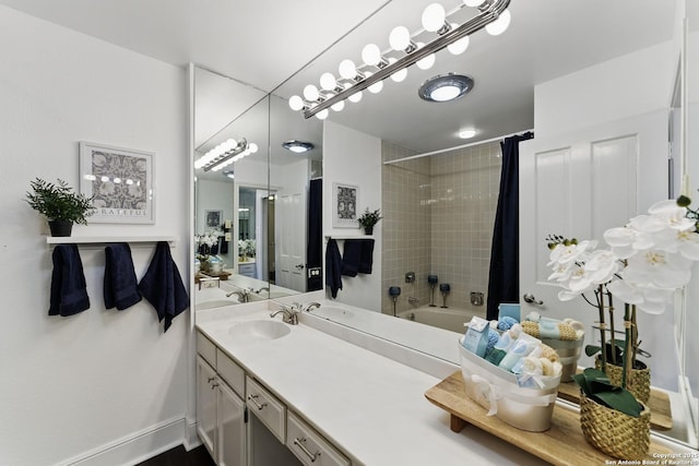 bathroom featuring vanity, baseboards, and shower / bathtub combination with curtain