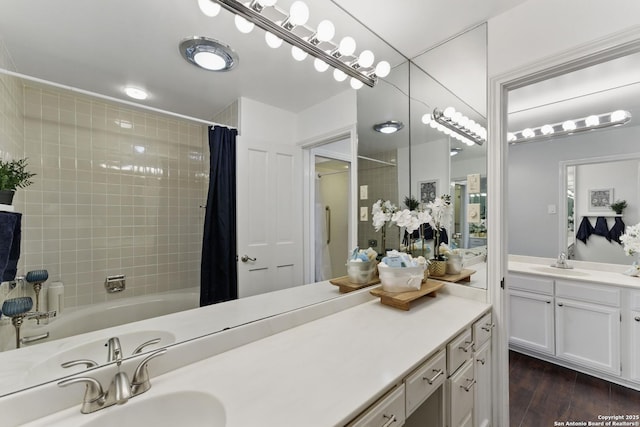 bathroom featuring vanity, shower / bathtub combination with curtain, and wood finished floors